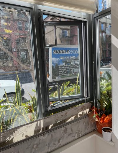 Standoff Screen Frame with Custom Wickets installed for Casement Window Handle Access